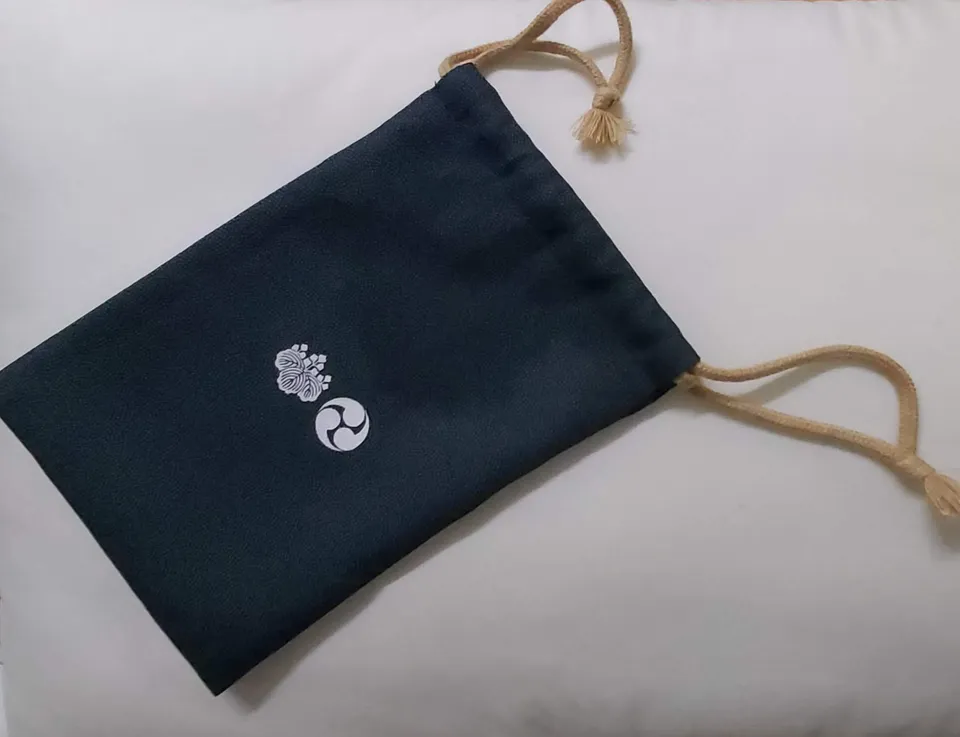 A drawstring bag protects the book and loose sheets